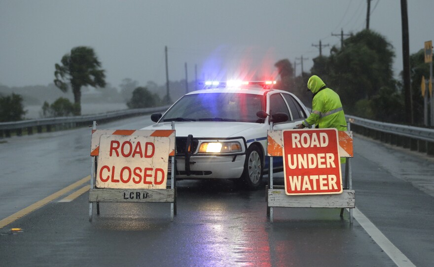 Police block the road entering Cedar Key, Fla., as Hurricane Hermine neared the Florida coast.
