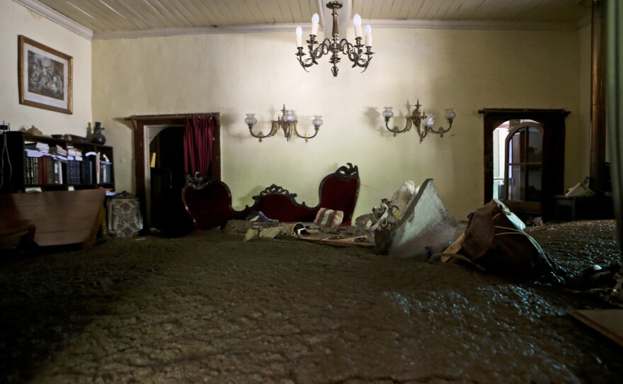 Sludge fills the living room of a home in Santiago on Sunday after rains triggered mudslides.