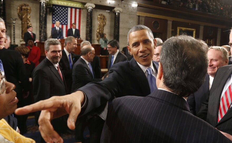 President Obama greets lawmakers as he leaves after giving the 2014 State of Union address before a joint session of Congress.
