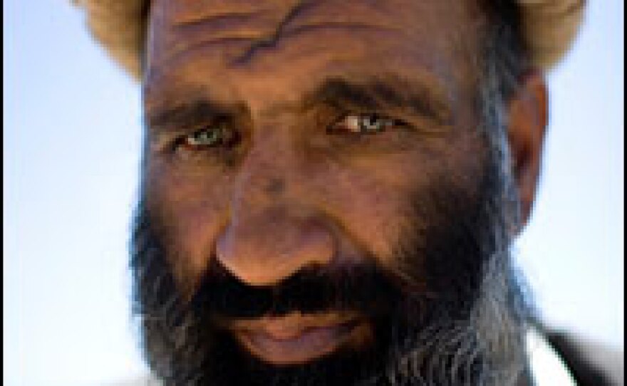 Bearing a fresh scar on his forehead, Tor Gol stands in the courtyard of the Nerkh District Center in Afghanistan's volatile Wardak province. The revered former mujahedeen commander who fought against the Soviets when they occupied the country was responsible for recruiting nearly all of the Afghan Public Protection Force Guardians from the district.