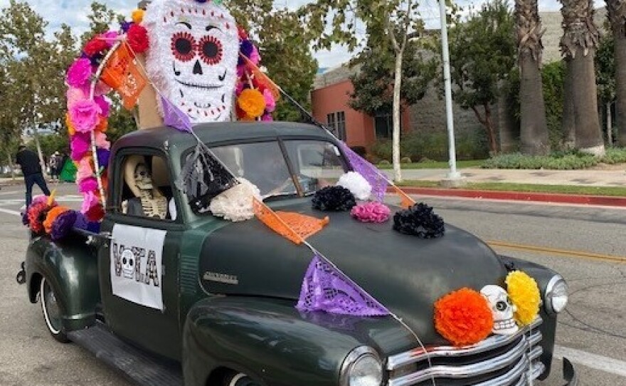 A participant drives in the Día de los Muertos car parade in East Los Angeles on Sunday.