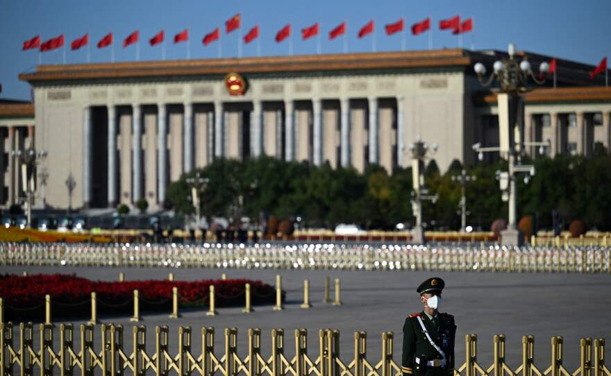 A member of the security staff keeps watch in front of the Great Hall of the People in Beijing.