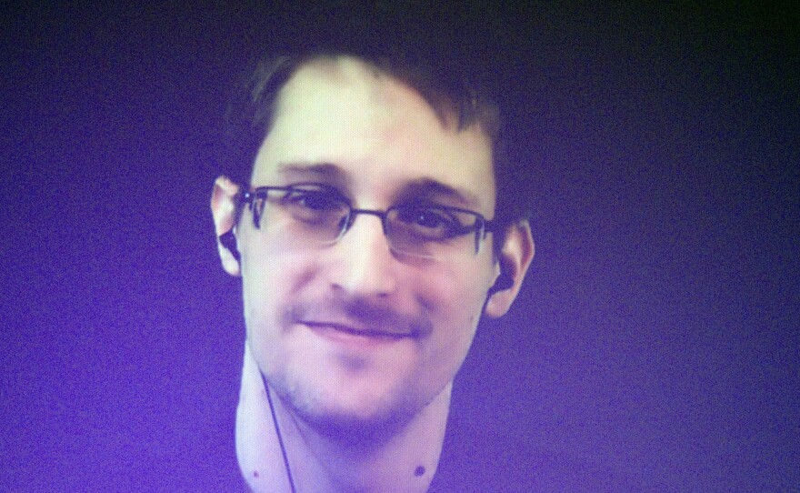 Edward Snowden, who is in Moscow, is seen on a giant screen during a live video conference for an interview as part of Amnesty International event in Paris in December 2014. The House Permanent Select Committee on Intelligence published a summary report accusing Snowden of causing "tremendous damage to U.S. national security."