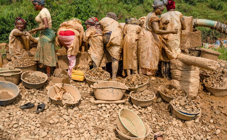 Women sift gold-bearing sediments at the Maidede mine in Mongbwalu on June 16. Gold mining drives the local economy and draws a highly mobile workforce, a factor that health officials say has complicated efforts to contain the Ebola outbreak.