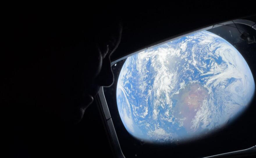 NASA astronaut and Artemis II Commander Reid Wiseman looks at Earth through Orion's main cabin windows as the crew travels towards the Moon. Wiseman and his three crewmates are set to return to Earth on Friday.