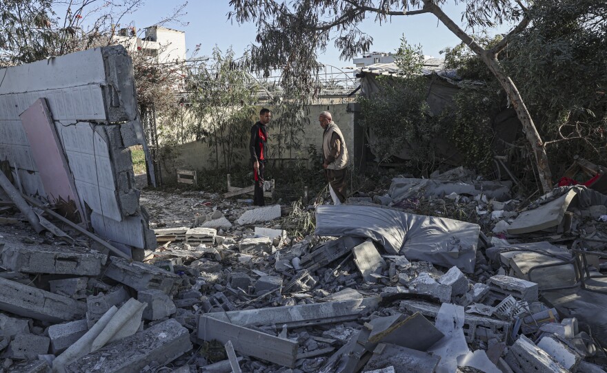 Palestinians search for their belongings amid the rubble of houses destroyed by an Israeli bombardment in Rafah in the southern Gaza Strip on March 11.