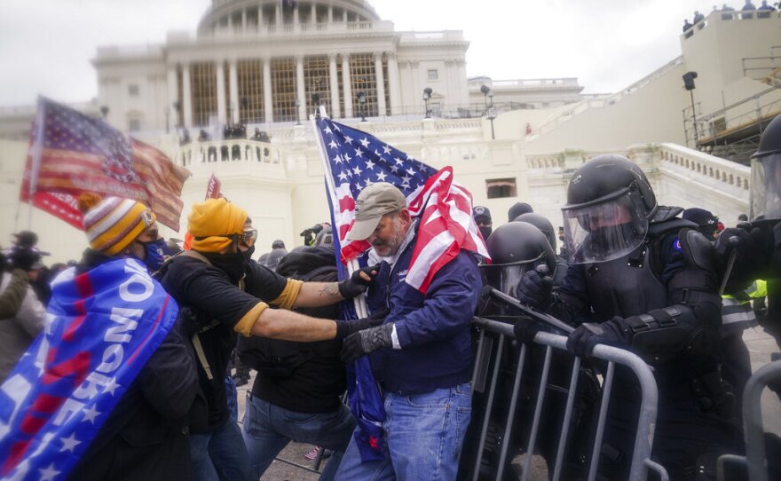 Rioters try to break through a police barrier at the Capitol in Washington on Jan. 6, 2021.