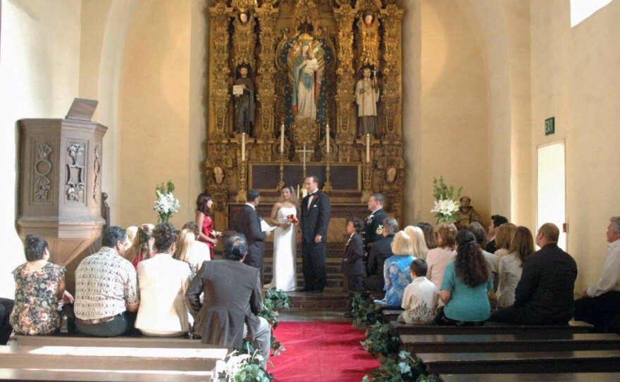 Liz and Gil Kennedy stand in front of the altar in the Museum of Man chapel, May 29, 2005.