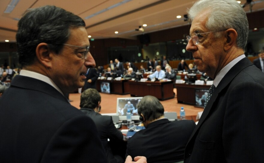 European Central Bank Chief Mario Draghi speaks with Italian Prime Minister Mario Monti at EU headquarters in Brussels on Wednesday. European leaders will meet there next week to discuss their options for fixing the region's sovereign debt crisis.
