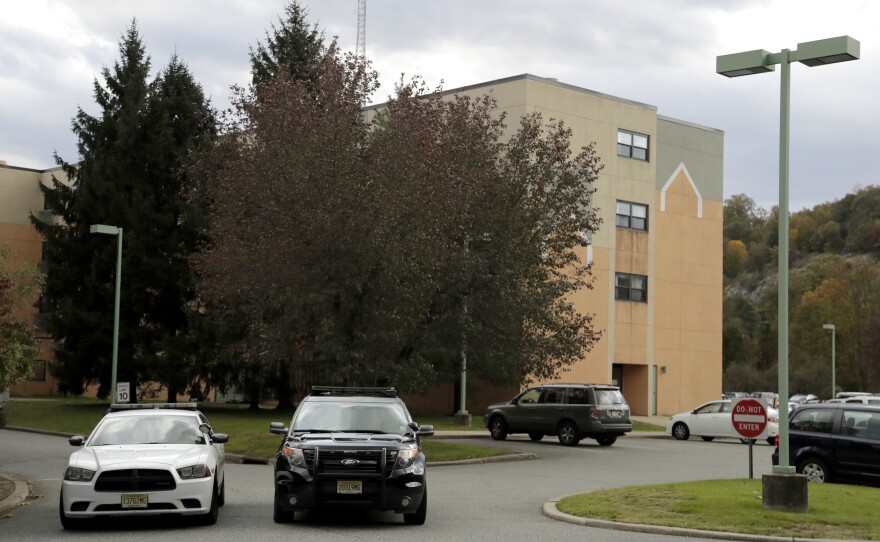 Police cruisers are parked near the entrance of the Wanaque Center for Nursing And Rehabilitation in Haskell, N.J., where the New Jersey Department of Health confirmed cases of adenovirus in October 2018. Dozens fell ill from the outbreak, and 11 died.