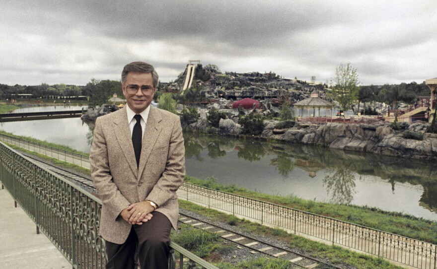 FILE - Television evangelist Jim Bakker poses in front of the Water Park in Columbia, SC, one of the attractions at his Heritage USA, March 19, 1987.