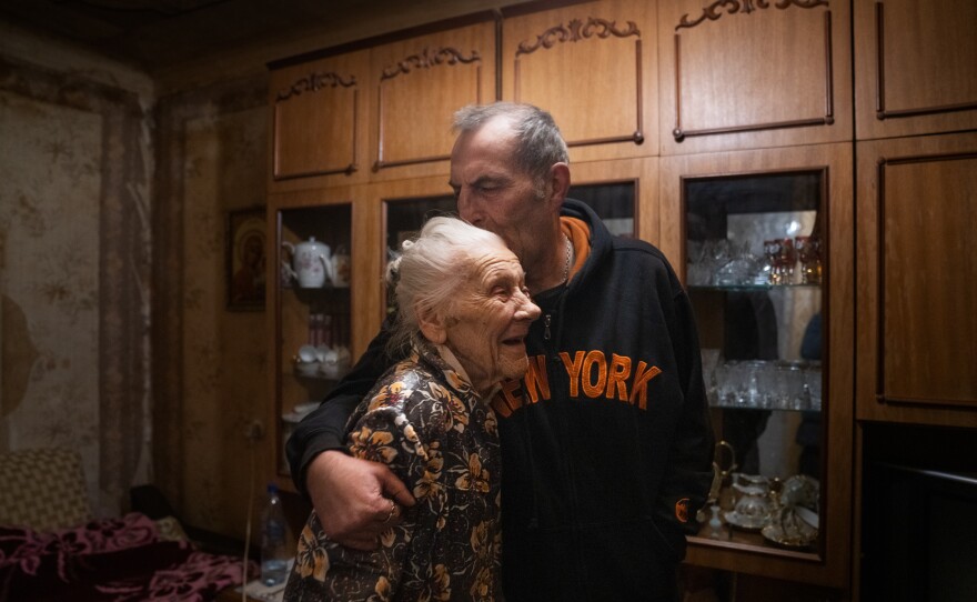 Nadiia Yerkhimovych and her son, Mykhailo, embrace each other in their apartment in Kyiv.