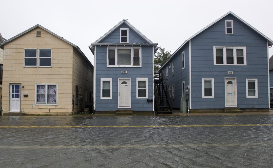 Houses are lined along flooded street in the downtown section of Ocean City, Md., on Saturday.