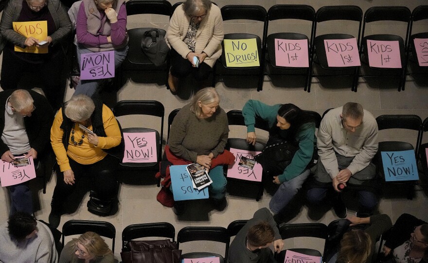 Supporters of Missouri's ban on gender-affirming care for minors gather on the floor of the statehouse in Jefferson City in March 2023.