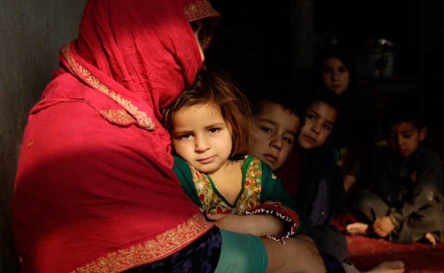 Shaista sits in her tiny home on the outskirts of Kabul. Her youngest, a 3-year-old girl, sits on her lap; some of her other seven children sit beside her. Behind them, she is boiling a pot of water on the wood-burning stove. But she's told the children it is dinner, and she tells them, "just wait for your father." Then she hopes they'll fall asleep, because there's no food to give them.