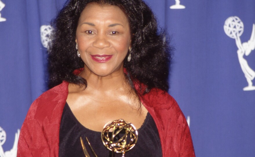 Actress Mary Alice holding her Emmy Award in the press room in 1993.
