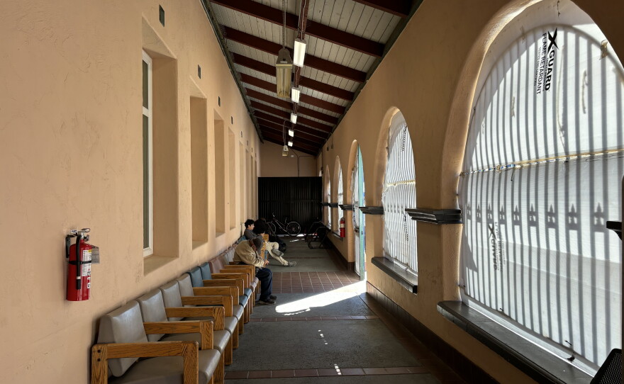 People sit in the chairs lining the alcove of the Father Joe's Villages day center on Oct. 14, 2026.