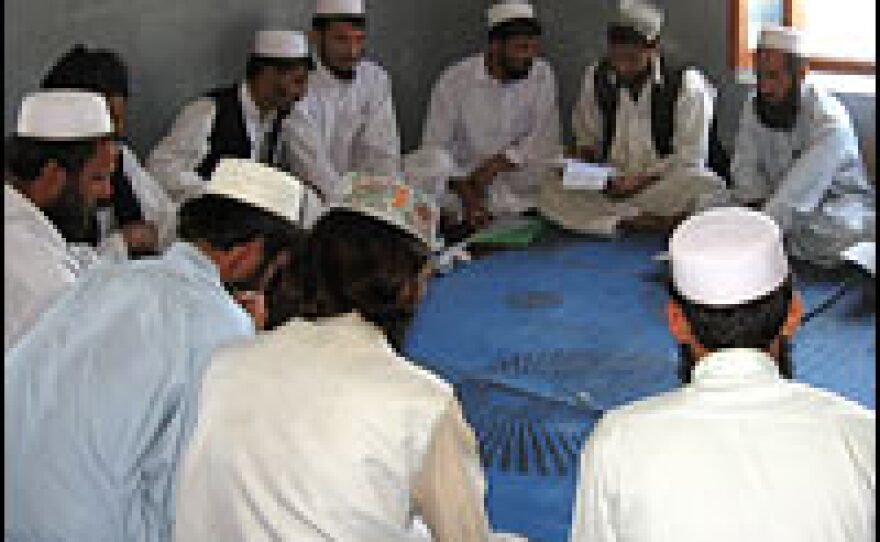 Students study the Prophet Mohammad's teachings in a classroom.