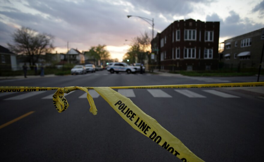 Police crime tape is displayed at the scene where a 16-year-old was shot and killed and an 18-year-old was shot and wounded on April 25 in Chicago.
