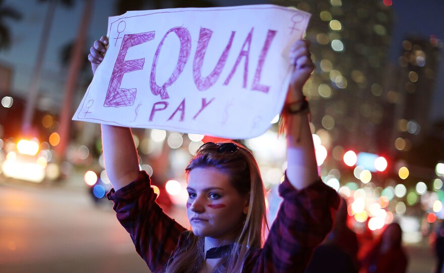 Clarissa Horsfall joins with others during "A Day Without A Woman" demonstration on March 8, 2017, in Miami. Employment attorneys say they've seen a spike in pay-disparity cases.