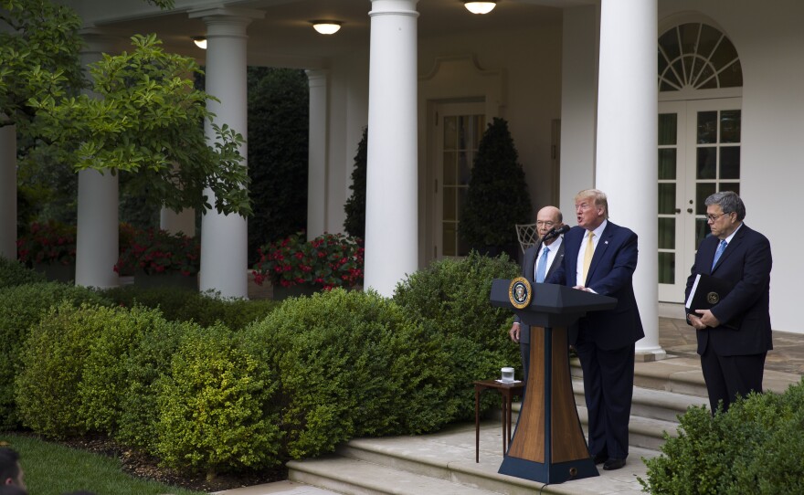 South Dakota has agreed to share driver's license and state ID records with the U.S. Census Bureau as part of efforts to carry out an executive order for citizenship data that President Trump announced in July 2019 with Commerce Secretary Wilbur Ross (left) and U.S. Attorney General William Barr in the White House Rose Garden.