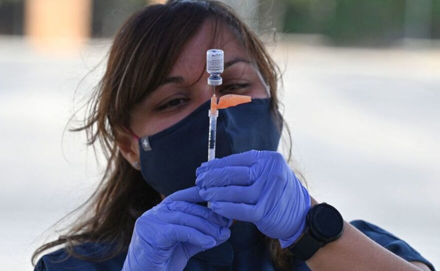 Booster shots are authorized for all U.S. adults, but some are wondering if they need them. A nurse fills a syringe with Pfizer-BioNTech Covid-19 at a pop up vaccine clinic in the Arleta neighborhood of Los Angeles, California.