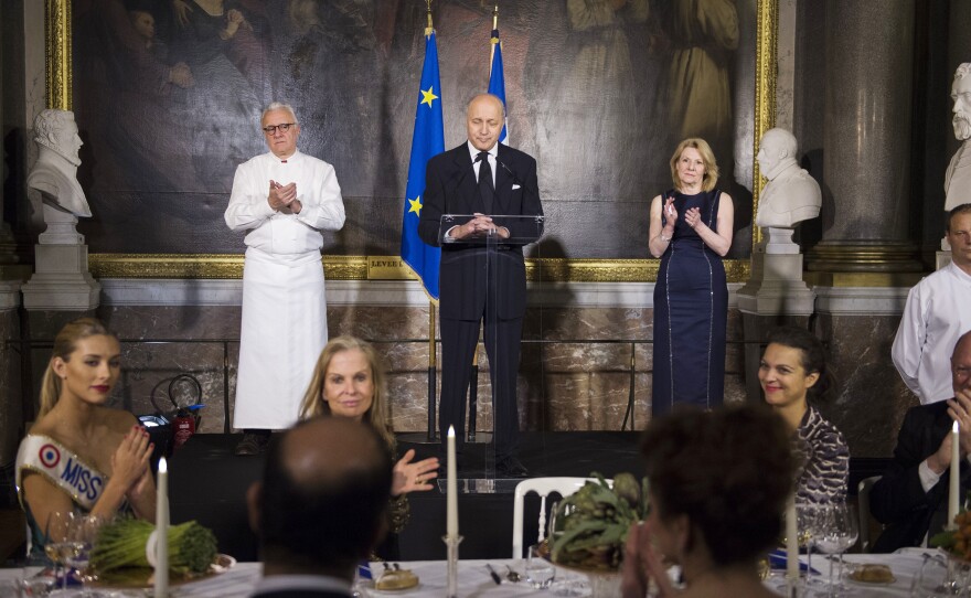French Foreign Affairs Minister Laurent Fabius (center) hosted the Gout de France dinner at the Palace of Versailles last Thursday. Famed French chef Alain Ducasse (left) helped the government plan the dinner party event, which was staged around the world — part of a concerted French effort to restore its culinary reputation. Versailles President Catherine Pegard is seen at right.