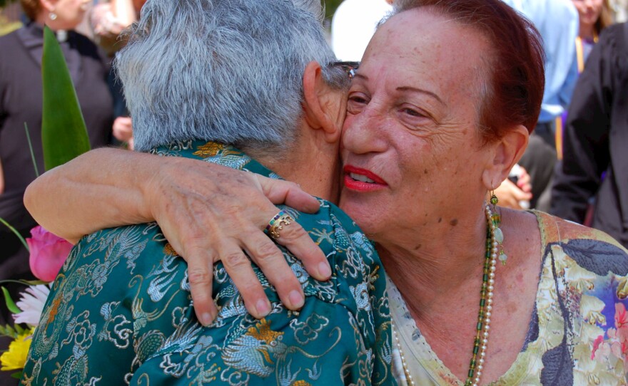 A couple hugs after getting married at Civic Plaza in Albuquerque.