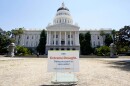 A sign about saving water is posted on browning grass outside the state Capitol in Sacramento, Calif., on Monday, July 11, 2022. California's water use dropped more than 10% in July compared to two years ago, state officials said Wednesday Sept. 7, 2022.