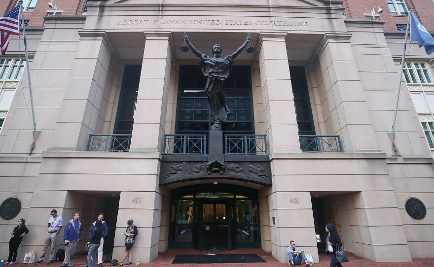 People wait in line to enter the Albert V. Bryan United States Courthouse to attend the trial of former Trump campaign chairman Paul Manafort on Tuesday in Alexandria, Va.