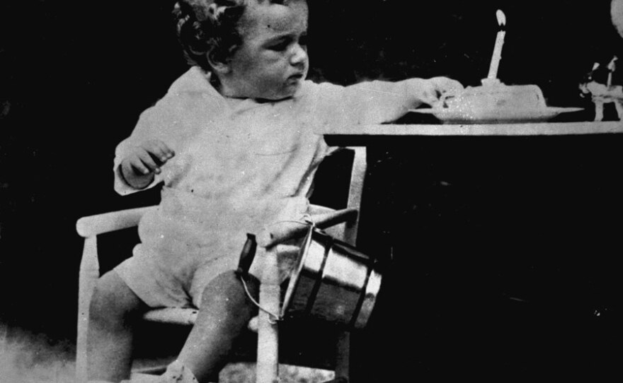 Baby Lindbergh with a piece of his first birthday cake.