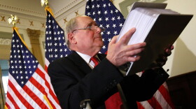 Holding a stack of evidentiary papers, Sen. Carl Levin (D-MI) answers questions relating to the disclosure of Goldman Sachs internal emails April 26, 2010 in Washington, DC. 