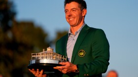 Rory McIlroy, of Northern Ireland, holds the trophy after winning the Masters golf tournament at the Augusta National Golf Club, Sunday, April 12, 2026, in Augusta, Ga.