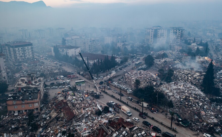 An aerial view shows smoke billowing from the scene of collapsed buildings in Hatay, Turkey on Wednesday.
