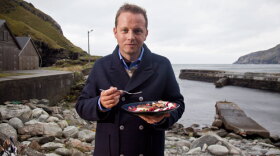 Host Andreas Viestad eats a brightly colored salad with smoked haddock while visiting the wind-blown peninsula of Stad in Western Norway.
