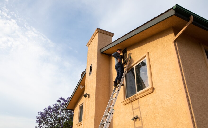 Bill Bozarth installs an ember resistant vent in a Lakeside home. June 15, 2021.