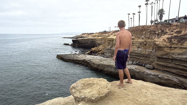 Enzo Bledsoe stands ready to cliff jump at Pappy's Point at Sunset Cliffs, Aug. 5, 2026.
