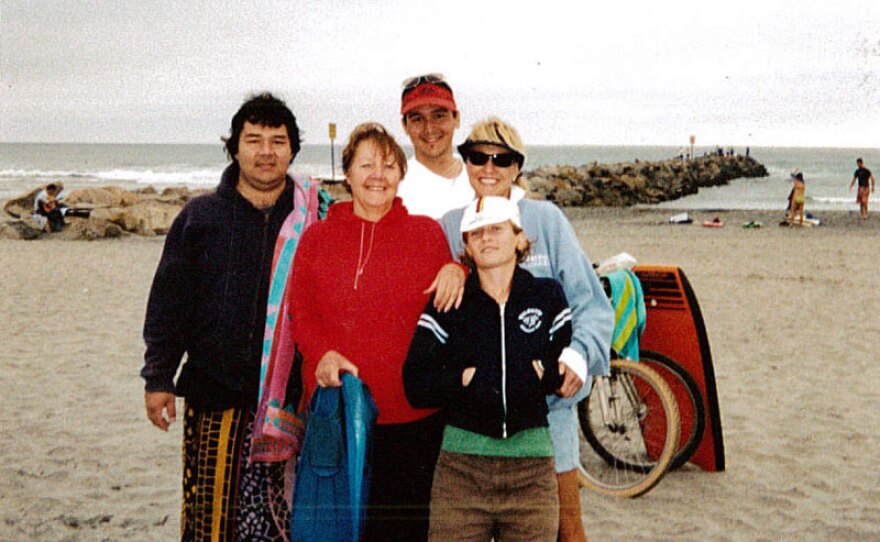 This undated photo shows Jason Nishimoto,left, posing with family and friends on a beach.