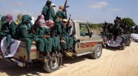 Armed fighters from the al-Shabab terrorist group travel on the back of pickup trucks outside Mogadishu in Somalia on Monday Dec. 8, 2008. 