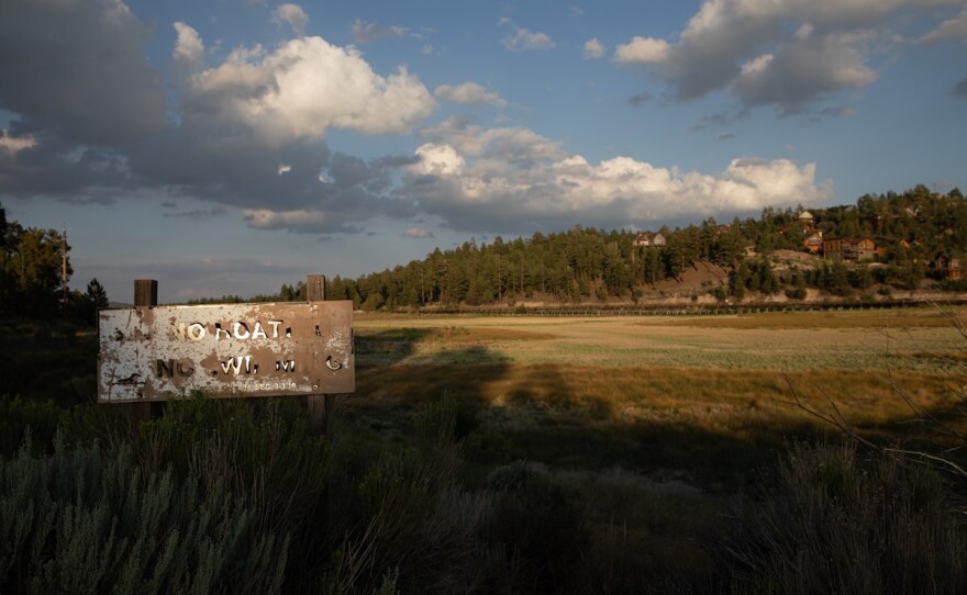 The West's historic megadrought has caused large parts of Big Bear Lake to dry up, rendering this “No Boating No Swimming” sign irrelevant. July 26, 2022.