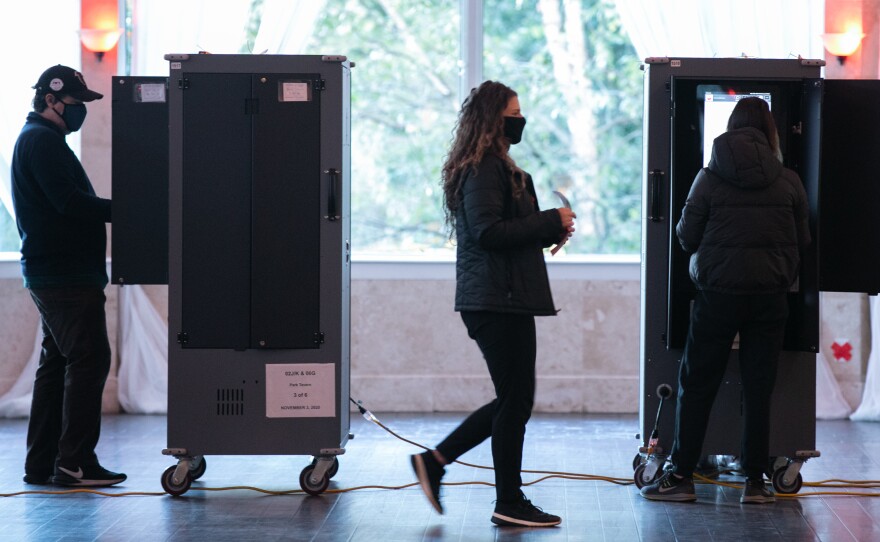 Voters in Atlanta casting their ballots on voting equipment made by Dominion Voting Systems. After losing the election, former President Trump and his allies spread conspiracy theories about the company, which has responded with defamation suits to combat the disinformation.