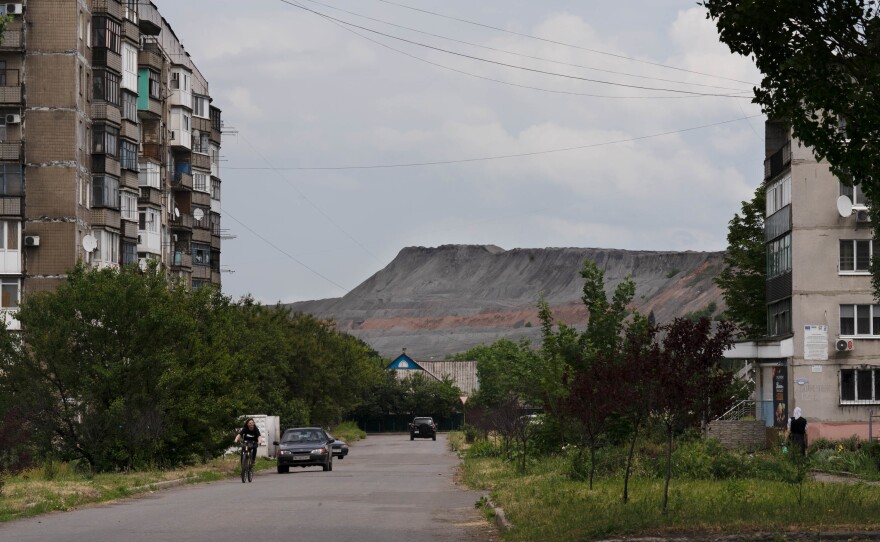 A slag heap rises behind residential buildings in Dobropillia, a town in the Donbas. Ninety percent of the country's coal is believed to be in the Donets coal basin in the Donbas region.