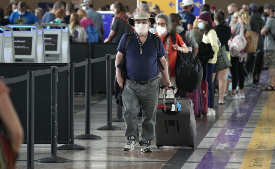 Travelers head to a security checkpoint at Denver International Airport on July 2. The economy likely surged in the April-June quarter as vaccine rollouts sparked a surge in pent-up activity. A slowdown is now seen as inevitable, although the pace of growth should remain strong.