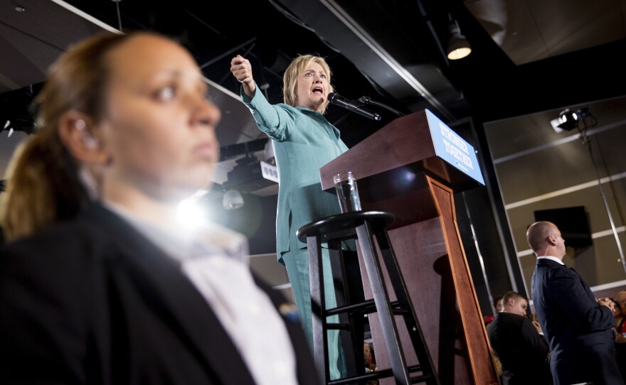 Members of the Secret Service stand guard near Democratic presidential candidate Hillary Clinton in August as she speaks at a rally at International Brotherhood of Electrical Workers Local 357 Hall in Las Vegas.