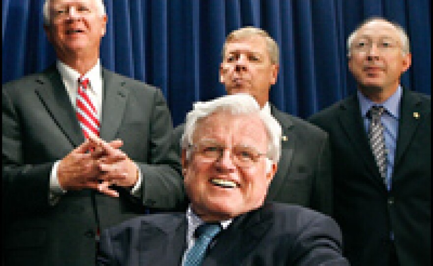 Senator Ted Kennedy (D-MA) laughs with (L-R) Sen. Saxby Chambliss (R-GA), Sen. Johnny Isakson (R-GA) and Sen. Ken Salazar (D-CO) as they announce a compromise on immigration legislation between the White House and the Senate.