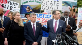 David Hearn (second from left) and his attorney Norman Eisen (right) addressed reporters after he entered his not guilty plea on July 9 in Washington, D.C.