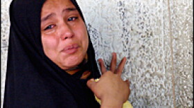 An Iraqi girl mourns the death of her father, an employee of a telephone exchange in Baghdad's Sadr city neighborhood. Four employees of a telephone exchange were shot dead as they arrived for work Sunday.