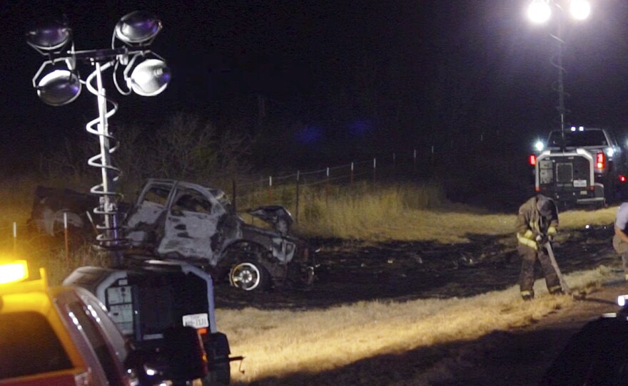 Emergency responders work the scene of a fatal crash late Tuesday in Andrews County, Texas. A vehicle carrying members of the University of the Southwest's golf teams collided head-on with a pickup truck, killing nine people, authorities said.