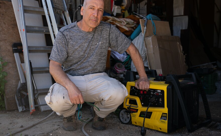 Raviv Kahan, 54, poses in his shed with a generator he bought in preparation for a possible war with the Hezbollah militia in neighboring Lebanon. Kahan volunteers in a civil search and rescue unit, and has outfitted his house in Rishpon, Israel, in case Hezbollah missiles knock out the electricity.
