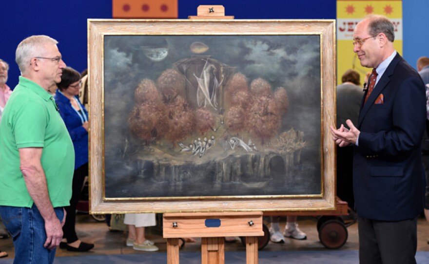 Alan Fausel (right) appraises a 1961 Leonora Carrington painting in Chicago, Ill.